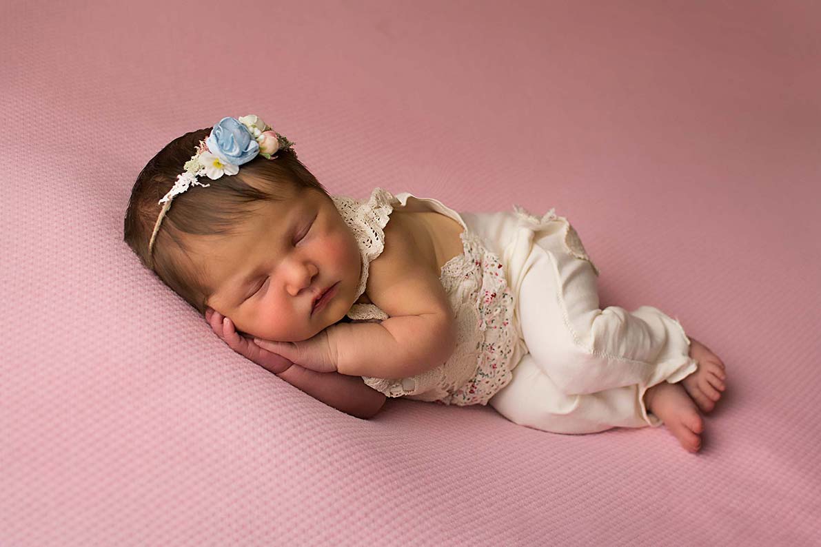 Newborn baby with pink backdrop, studio shooting
